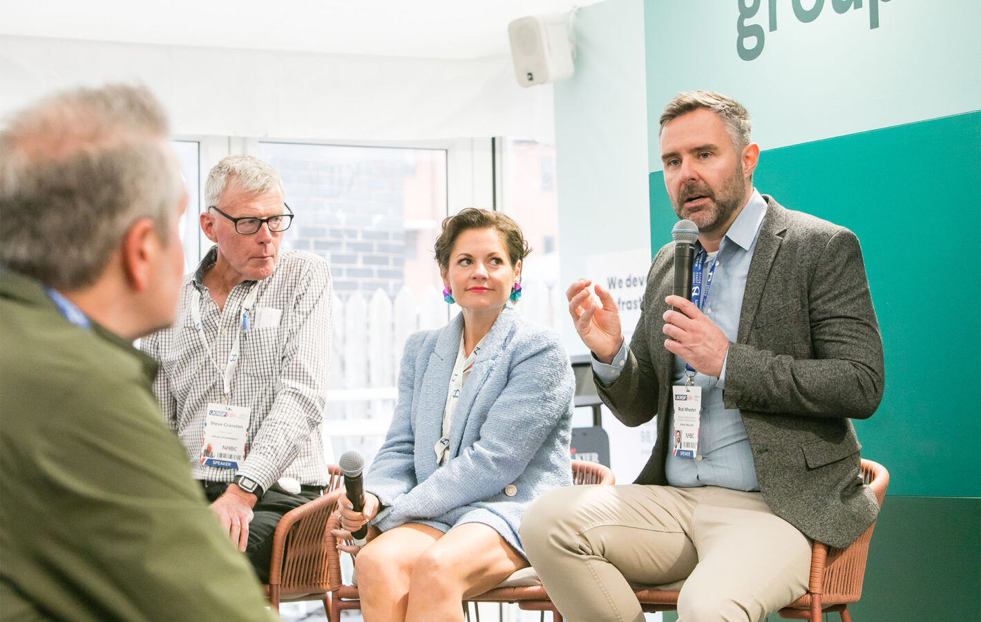 Rob discussing the Tai ar y Cyd Pattern Book at a UKREiiF panel event in 2025. Photo © Cratus Group.